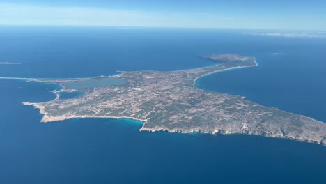 formentera island, in spain, aerial panoramic view shot from a jet cabin departing from ibiza island