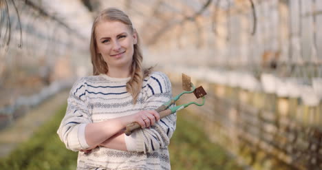 Successful-Female-Gardener-Holding-Hoe-2