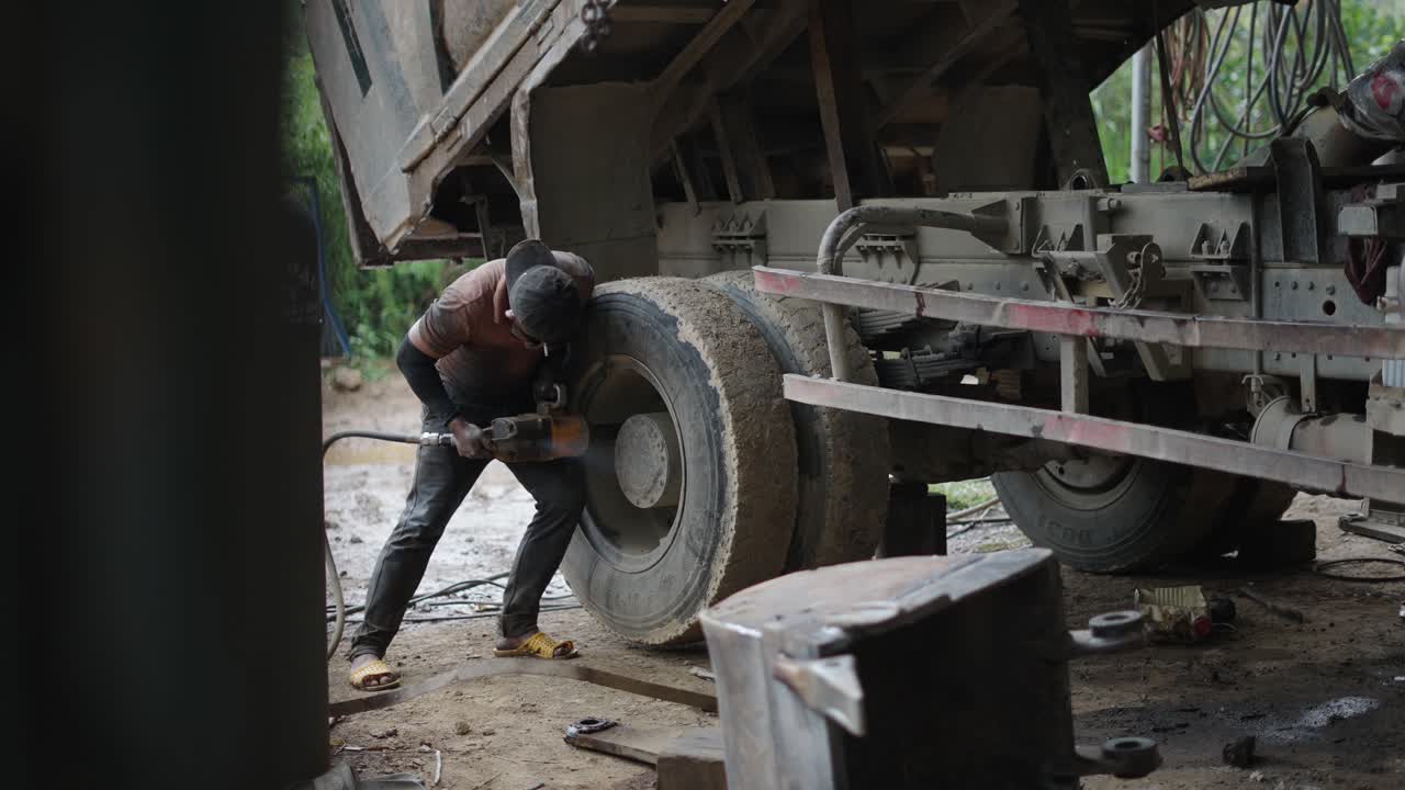 Truck Mechanic Working on a Tire
