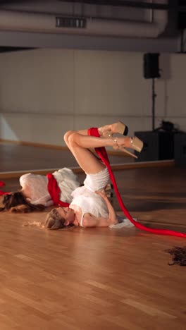 contemporary dance performance with red ribbons