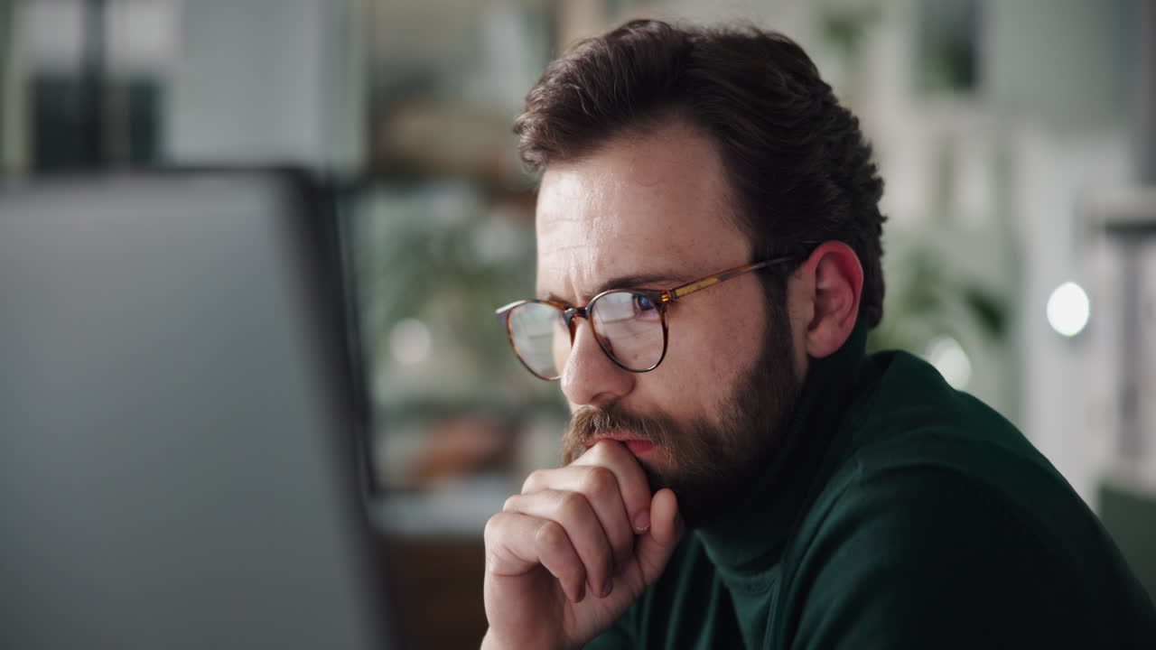 Man thinking in front of computer