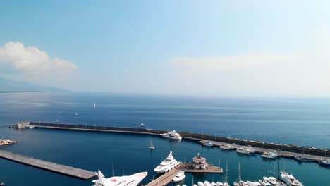 aerial, marina di riposto full of luxury yachts on calm morning, pedestal down wide shot