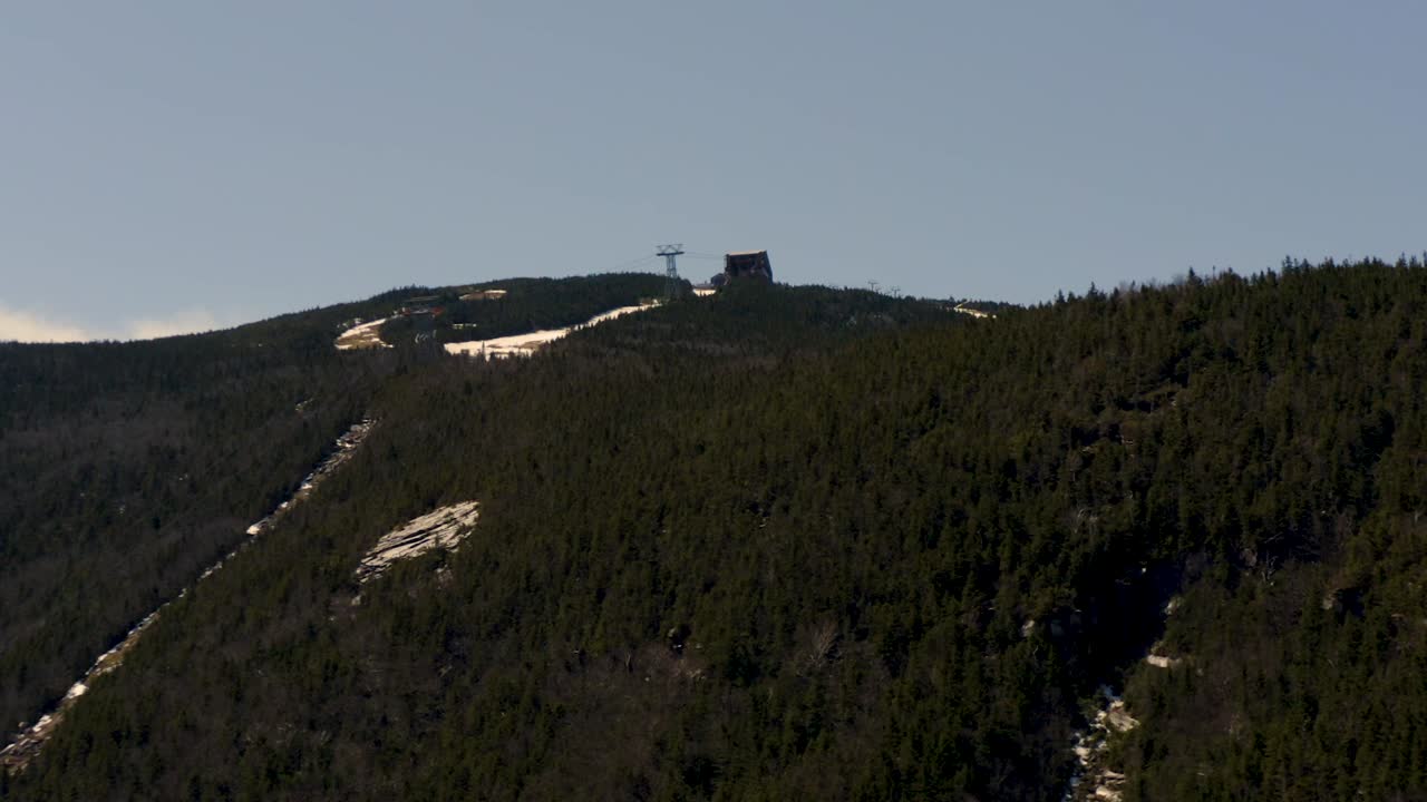 Drone Aerial ski mountain historic tram building reveal snow melt HD 30p