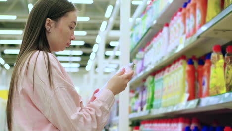 woman shopping for cleaning supplies in a grocery store