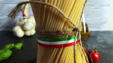 closeup shot italian spaghetti pasta italy flag kitchen tomato garlic basil rope tied view, kitchen with cooking ingredients close up spinning