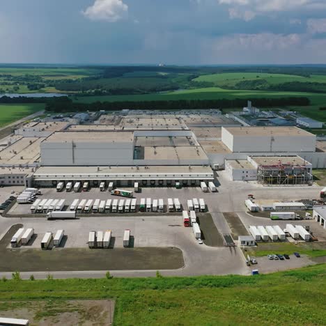 modern industrial zone among green nature. large territory of manufacture on the field in the countryside. aerial view.