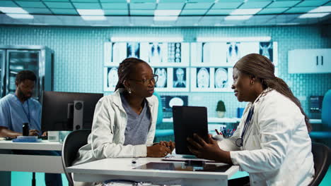 female doctor using clinical scans and records to advise a patient