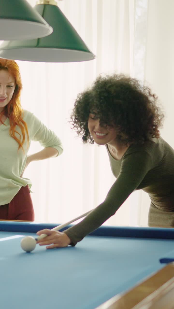 Beginner player hitting a billiard ball and laughing happy