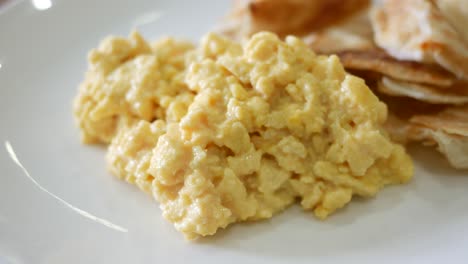 fried eggs mixed with bread on plate ,