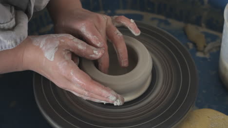 a person making pottery for sale