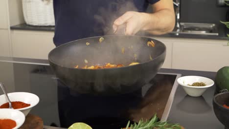 a cook tossing ingredients in the cooking pan with some professional tricks