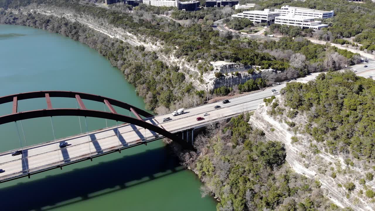 Aerial Austin Pennybacker Bridge descending towards the bridge and main overlook area, good view of the cliffs on the right