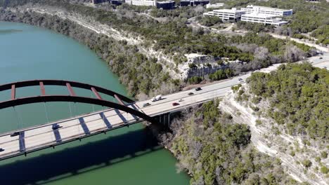 aerial austin pennybacker bridge descending towards the bridge and main overlook area, good view of the cliffs on the right