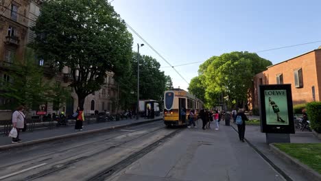 people boarding tram on milan street