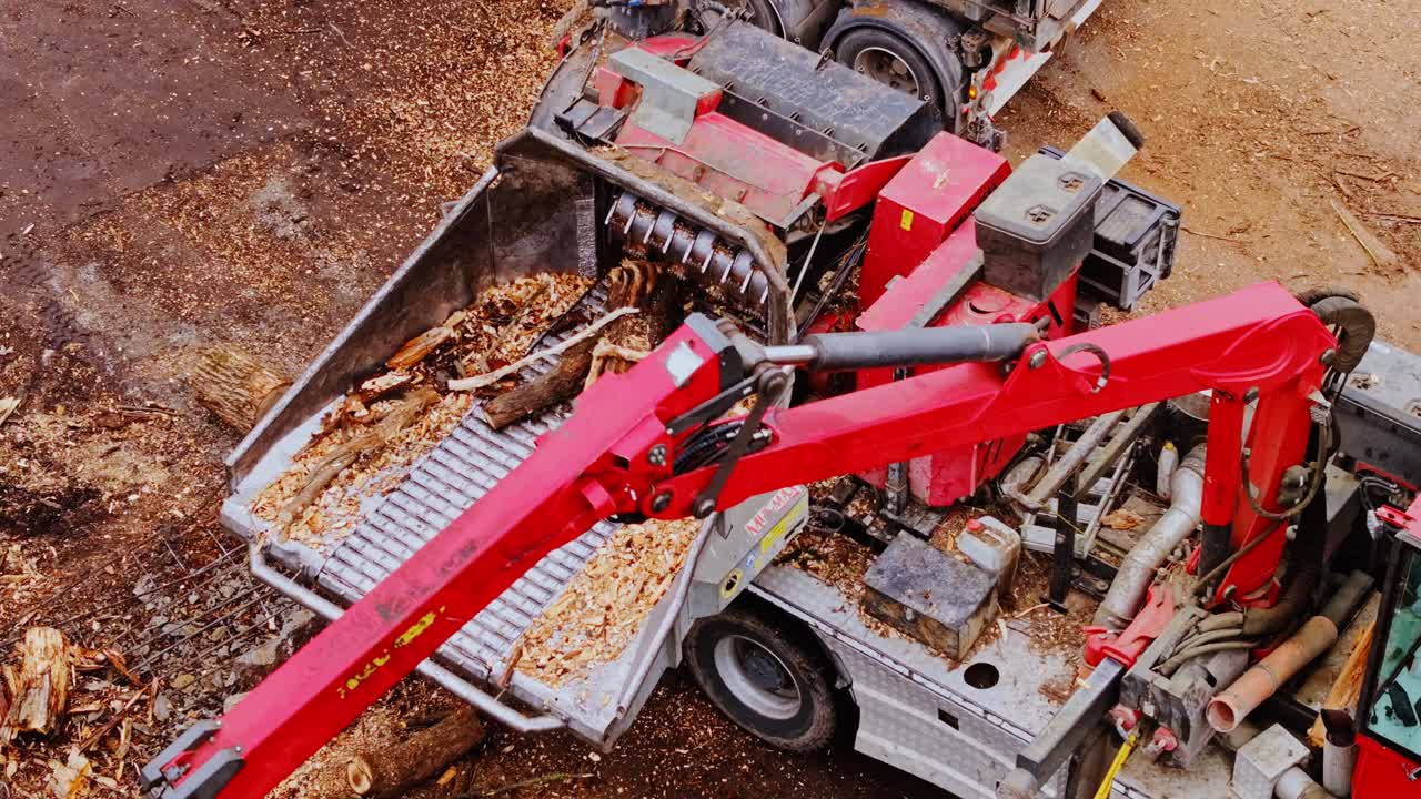 Powerful lumber processing machine transforming logs into finely ground sawdust