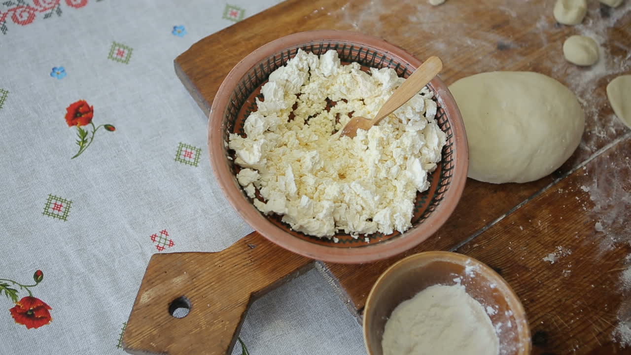 Making ukrainian dumplings. Woman preparing dumplings on wooden bord for boiling