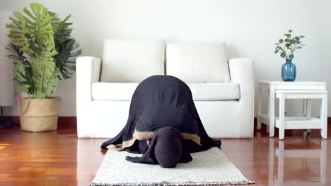 young muslim female praying and practicing the islamic faith