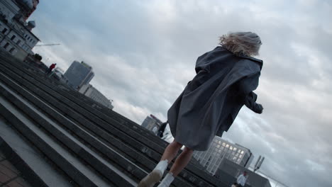 Lady-walking-up-stairs-in-modern-city-view-at-urban-background.