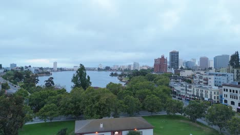 static drone view above lake merritt blends natural reflections with oakland’s diverse skyline