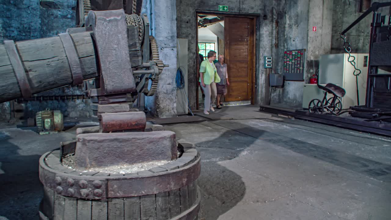 A woman guiding a group of tourists in the Ironmaking museum, Slovenia