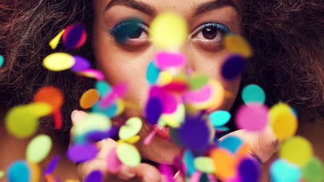 woman blowing confetti