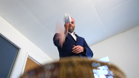 close up of a a business man is throwing away a paper document in to a waste paper bin basket after receiving bad news