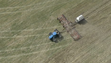 aerial view of farmer in tractor seeding