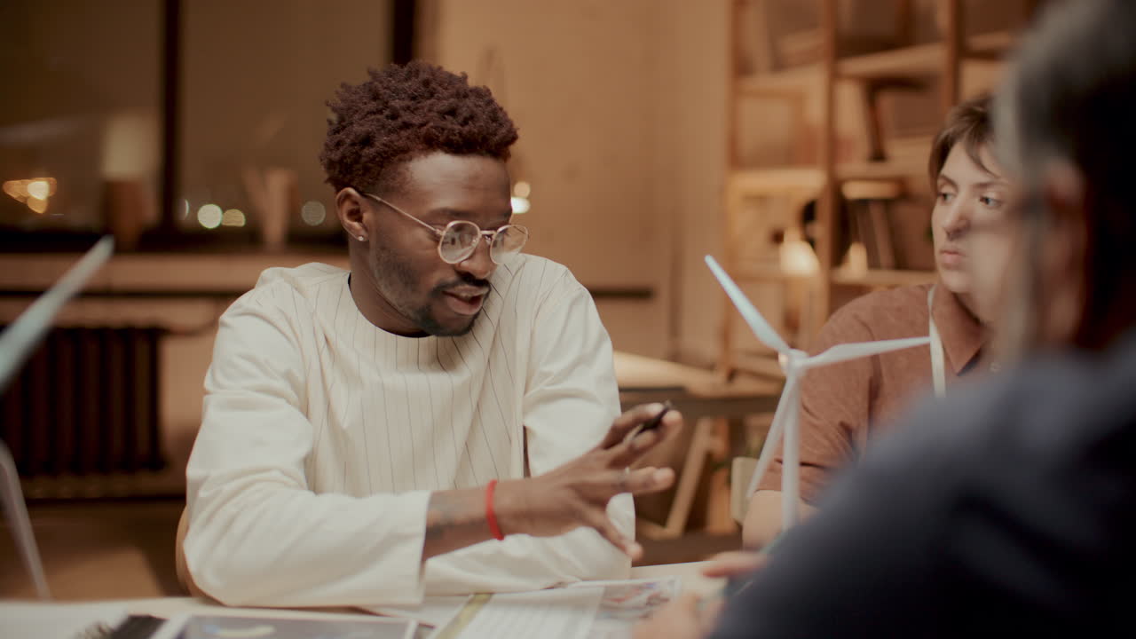 Team of Engineers Discussing Sustainable Energy Project in Office