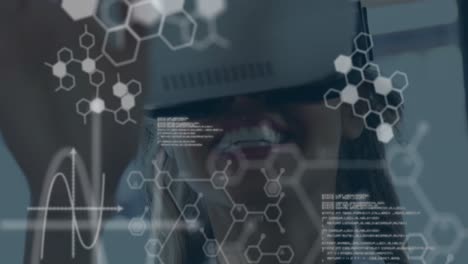animation of computer language and hexagon over young female entrepreneur using vr headset
