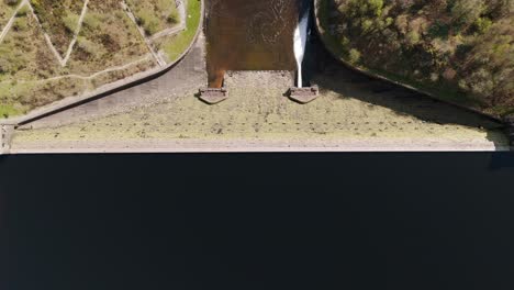 An-aerial-view-of-Caban-Coch-dam-and-reservoir-on-a-sunny-spring-day-in-the-Elan-valley,-Powys,-Wales