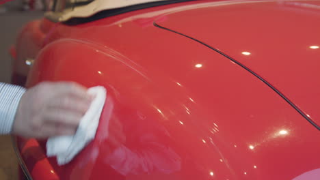 close up of red convertible getting waxed