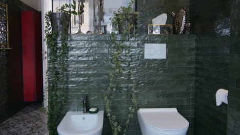 modern dark green bathroom with plants and glass shower