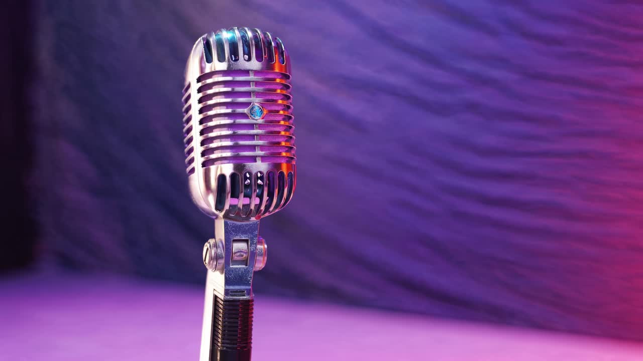 Vintage Microphone on Stage with Dynamic Colorful Lighting and Smoke