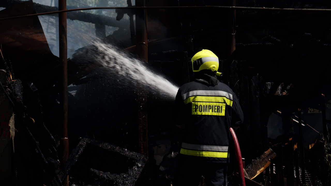 Firefighter trying to extinguish a house on fire