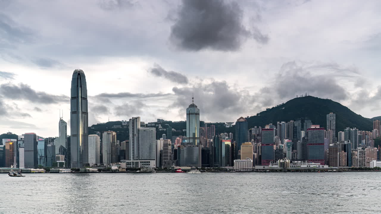 Time lapse of Cloudy day in Victoria Harbour Hong Kong skyline at spring afternoon