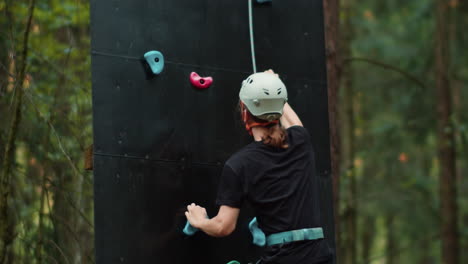 person climbing wall outdoors