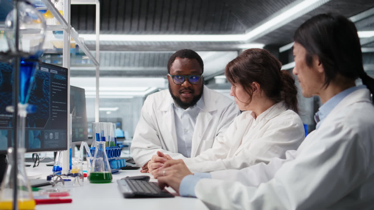 Vertical video Diverse team of research facility professional using PC software