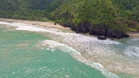 Aerial-view-of-showing-waves-of-Caribbean-Sea-reaching-empty-sandy-beach-of-Playa-El-Valle-in-Nature