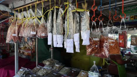 various dried seafood hanging at a market stall