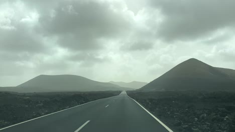 dash cam point of view driving in lanzarote with volcanoes