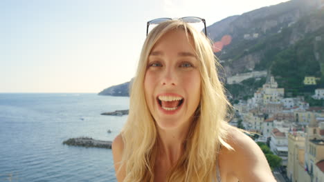 happy selfie of woman by the sea in italy