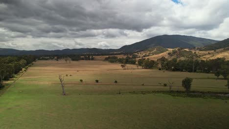 Over-paddocks-towards-the-mountains-surrounding-Eildon,-Victoria,-Australia