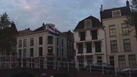 Dutch-flag-hanging-on-historic-student-housing-'Huize-Welgelegen'-in-city-in-the-Netherlands-on-national-holiday-King's-Day