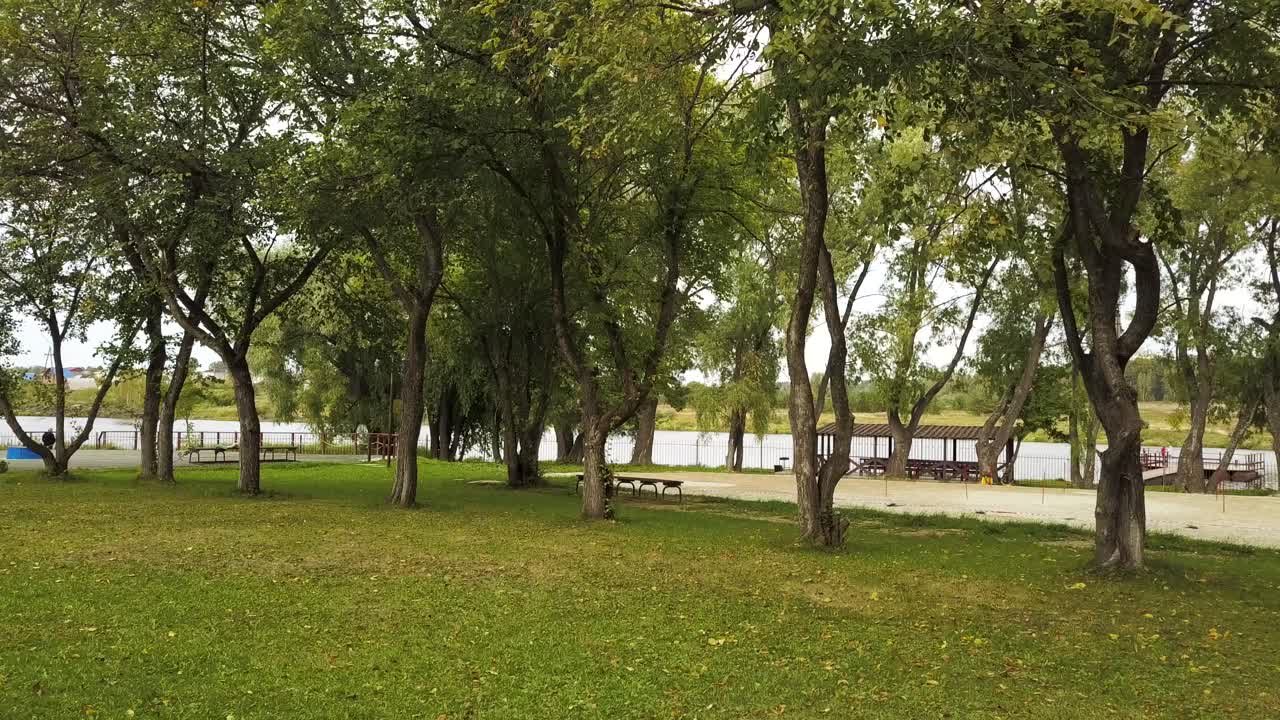 Park by the River with Trees and Play Area