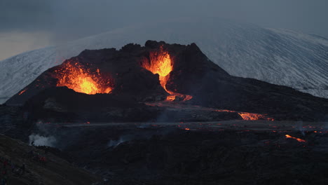 erupting volcano and molten magma in geldingadalir, iceland - wide shot