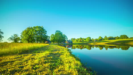 sunset timelapse on the shore of a small lake in wonderful green scenery