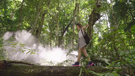 woman hiking in a lush tropical forest