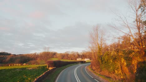 countryside road in uk glastonbury at golden hour with farm and fields