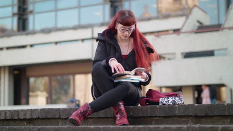 young woman student studying outdoors on campus