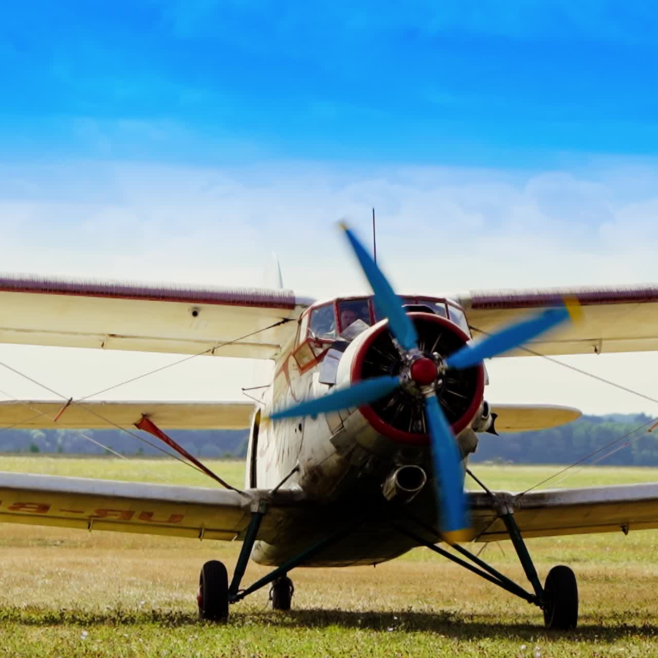 Old little airplane approaching the camera. Aircraft landed in the field on sunny weather. Extreme sport and adventure concept